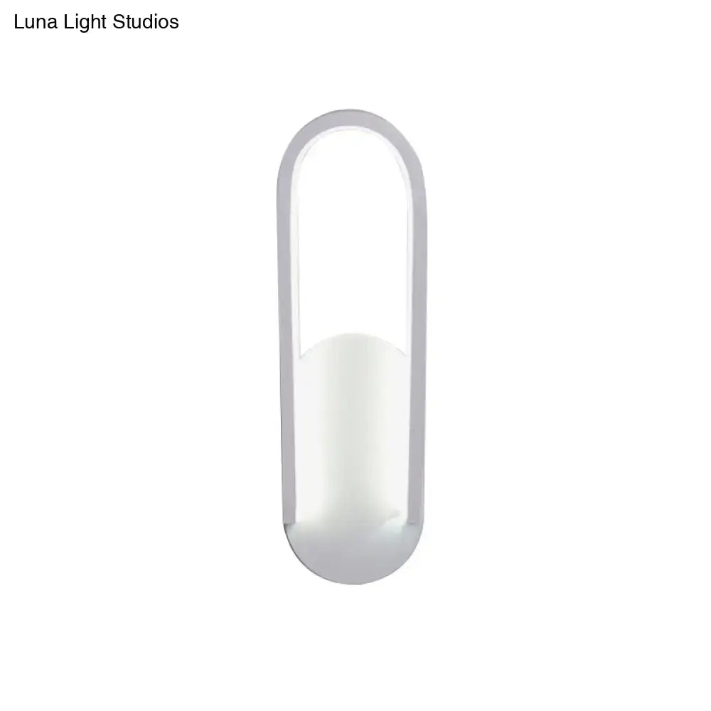 Modern black and white oval led wall sconce with warm white color temperature and sleek minimalist curved edges design