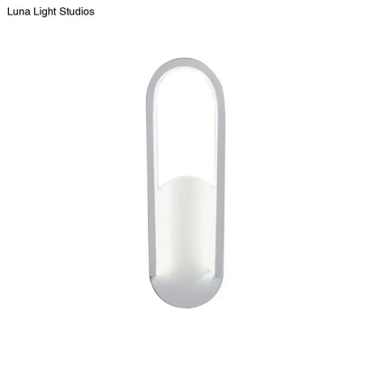 Modern black and white oval led wall sconce with warm white color temperature and sleek minimalist curved edges design
