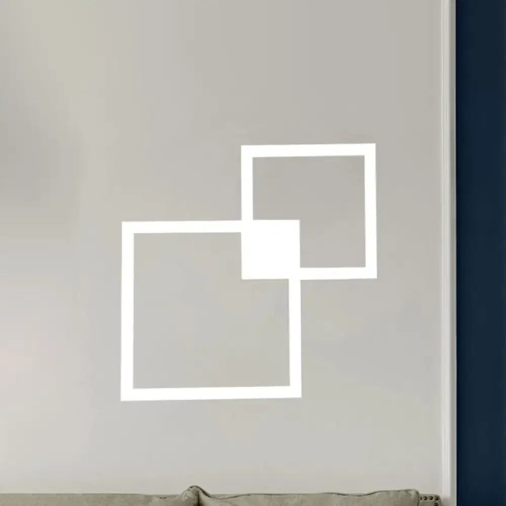 White geometric wall sconce with black and white overlapping square acrylic shade for dining room wall decor