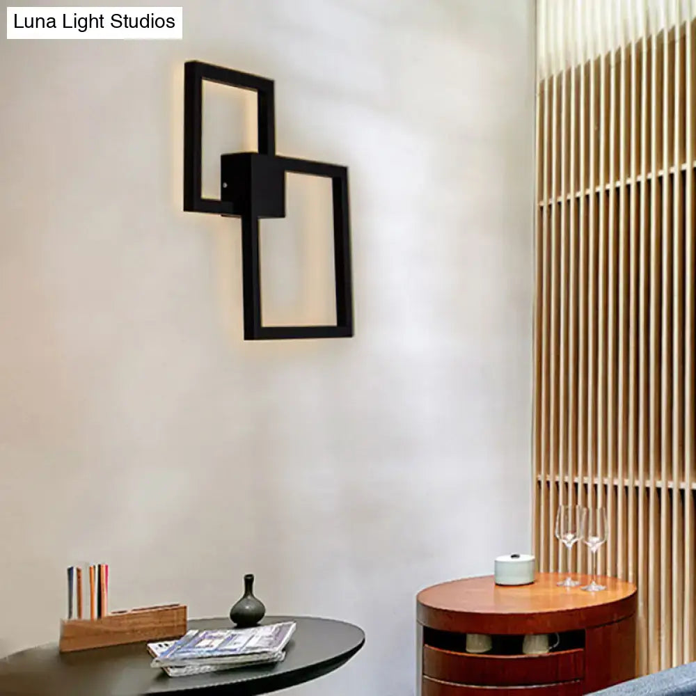 Modern black wall sconce with interlocking frame and acrylic shade for dining room lighting decor