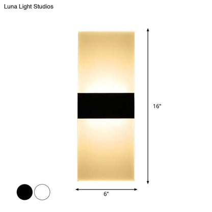 Modern black white rectangular led sconce featuring a sleek black horizontal band and warm diffused golden light for living rooms