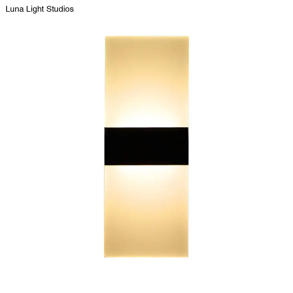 Modern black white rectangular led sconce with a sleek black band and warm diffused glow for living room walls