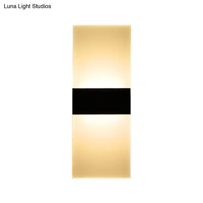 Modern black white rectangular led sconce with a sleek black band and warm diffused glow for living room walls
