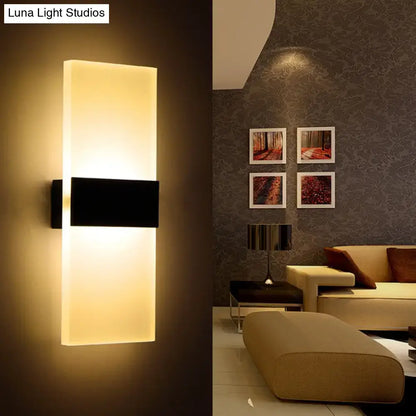 Modern black white rectangular led sconce with a warm glowing translucent panel and sleek black horizontal accent for living room