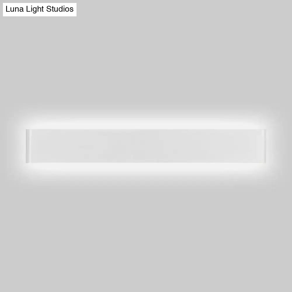 Modern black and white wall lamp with rectangular metal shade and sleek white finish illuminating living room space