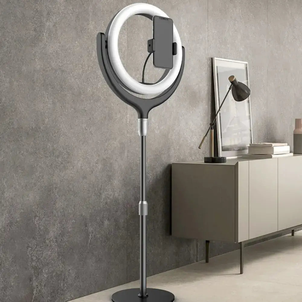 A sleek modern black and silver led mirror lamp with ring led mirror and phone stand for bedroom use