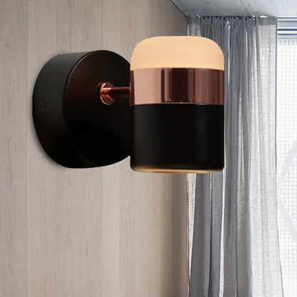 Modern black white rotatable led spotlight wall sconce with sleek black and rose gold finish and warm cylindrical lampshade glow
