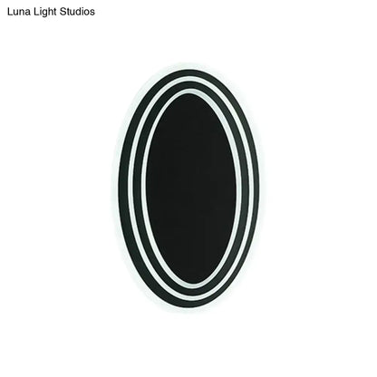 Modern black and white rotatable led wall light fixture with black oval sticker and three concentric white borders