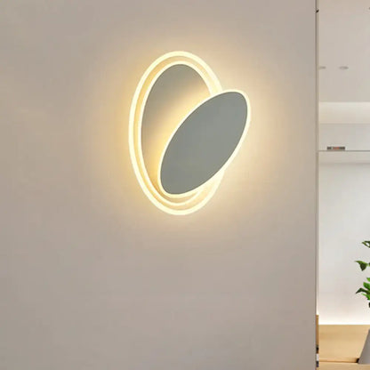 Modern black and white rotatable wall light fixture with oval warm glowing led ring and matte gray inner panel