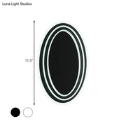 Modern black and white rotatable led wall light fixture with a sleek double-rimmed oval mirror for bedroom wall light