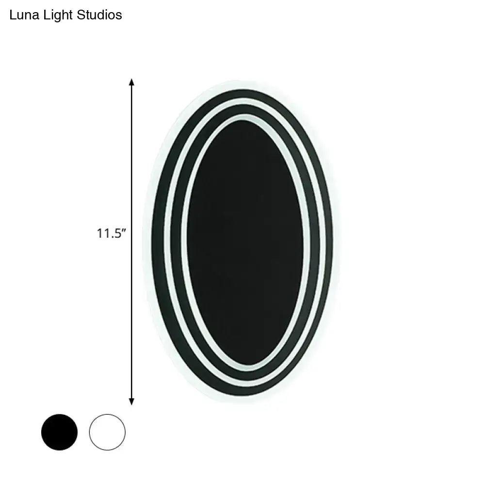 Modern black and white rotatable led wall light fixture with a sleek double-rimmed oval mirror for bedroom wall light
