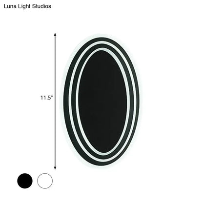 Modern black and white rotatable led wall light fixture with a sleek double-rimmed oval mirror for bedroom wall light