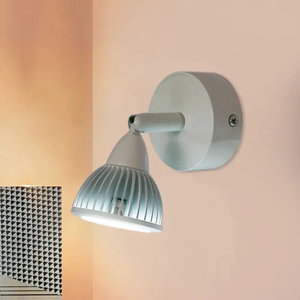 Modern black and white wall light with rotatable spotlight, sleek metallic arm, and ribbed frosted glass shade for bedroom use
