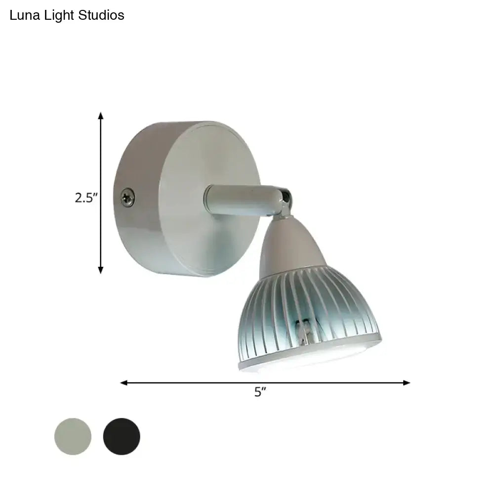 A sleek modern black white wall light with rotatable matte white and ribbed aluminum LED spotlight for bedroom use