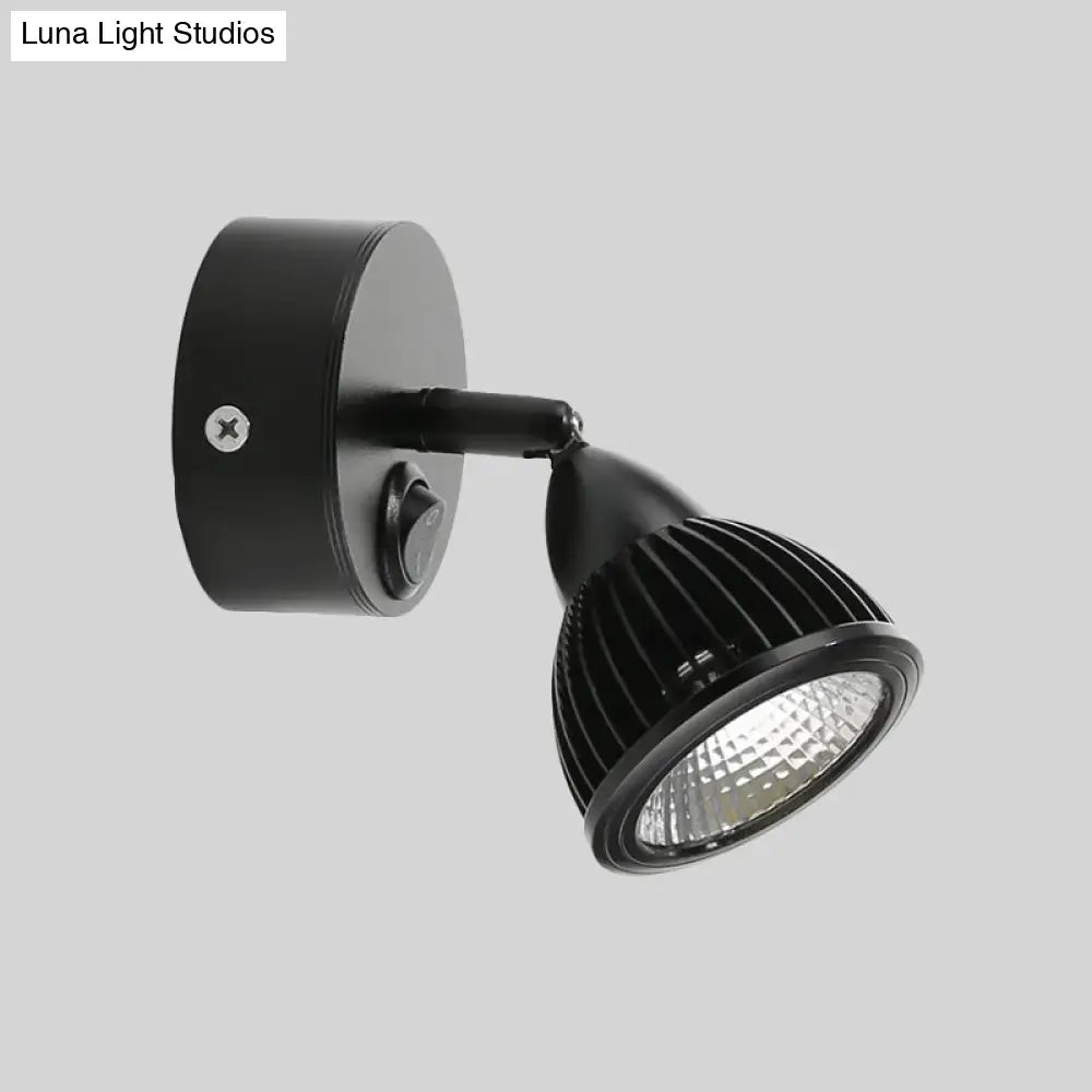 Modern black and white rotatable wall light with black led spotlight and ribbed heat-dissipating housing for bedroom use