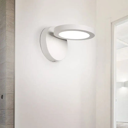 Modern black and white rotating wall light fixture featuring a sleek white circular wall light with minimalist design