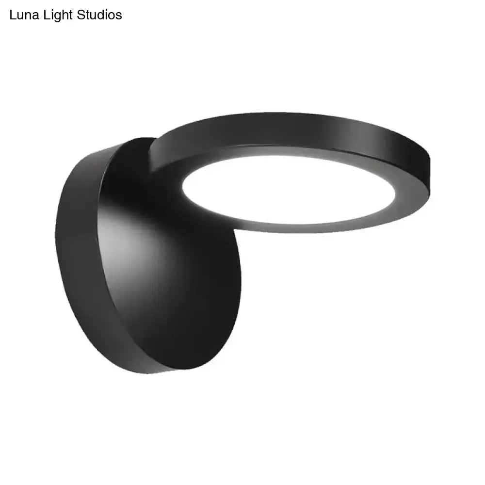 Modern black circular wall light fixture with sleek rotating design for bedroom glow and contemporary ambiance
