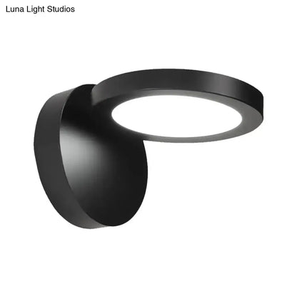Modern black circular wall light fixture with sleek rotating design for bedroom glow and contemporary ambiance