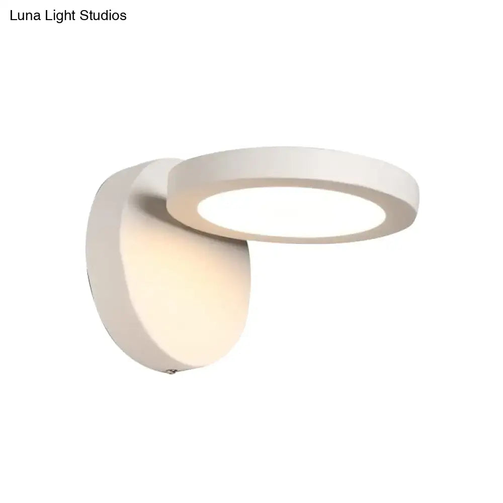 Modern white circular wall light fixture with a sleek minimalist design for bedroom glow and rotating functionality