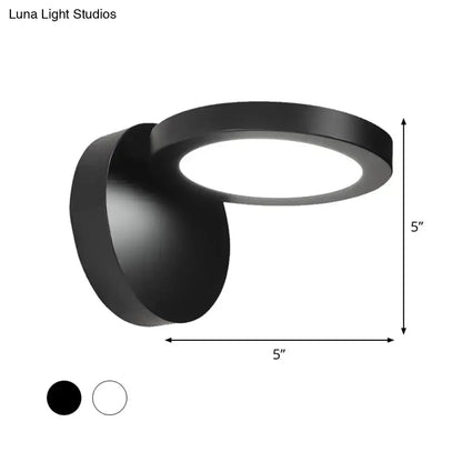 Modern black matte-finished circular wall light fixture with sleek design for bedroom glow and rotating feature