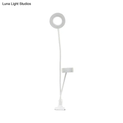 White flexible round usb mirror lamp with black clip base and phone holder for modern bedroom use
