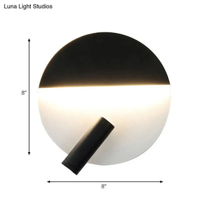 Modern black and white round wall lamp with an 8-inch circular LED wall light emitting soft ambient light for bedroom use