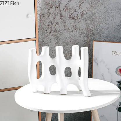 Modern black and white decorbites ceramic vase with abstract organic design and circular cutouts for living room decor