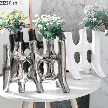 Shiny silver ceramic vase with modern abstract vertical openings for living room decor by decorbites ceramic vase