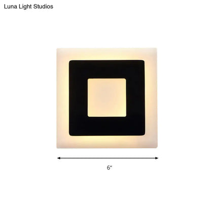 Modern black and white square wall sconce lamp with matte white frame black inner border and warm glowing light panel