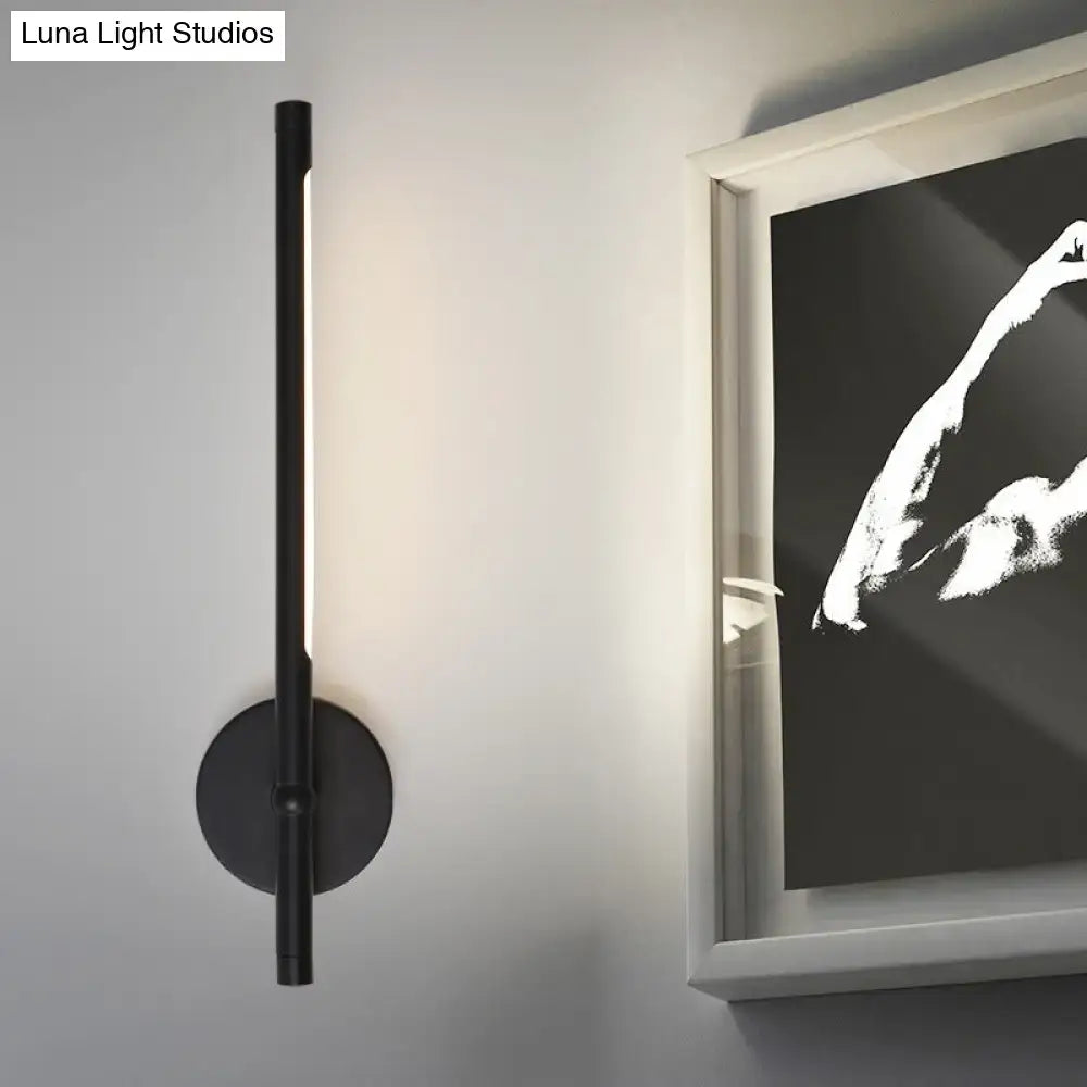 Modern black and white tubular direct wired led sconce with cylindrical design and circular base for bedroom lighting maximum bulb wattage