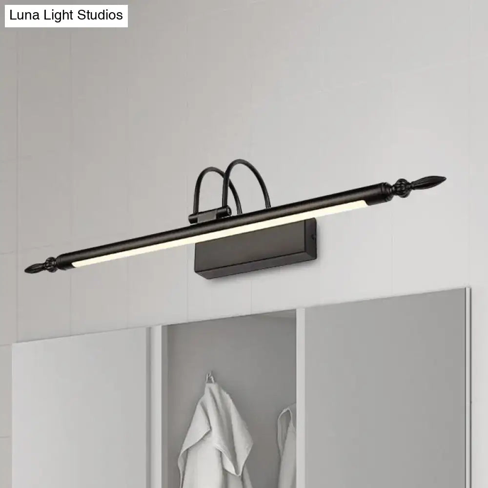 Black metal vanity lighting with sleek elongated design and ornate finials emitting white warm light for bathroom use
