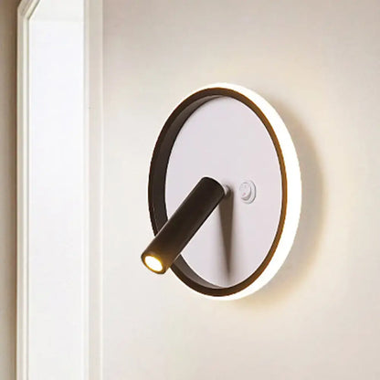 Modern black and white wall light featuring a circular illuminated ring base and adjustable cylindrical head with white warm light