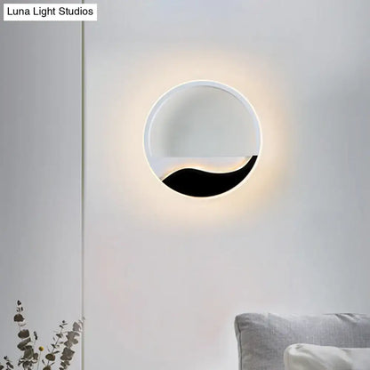 Modern black and white wave led flush mount wall light with sleek frame emitting warm ambient light for bedroom use
