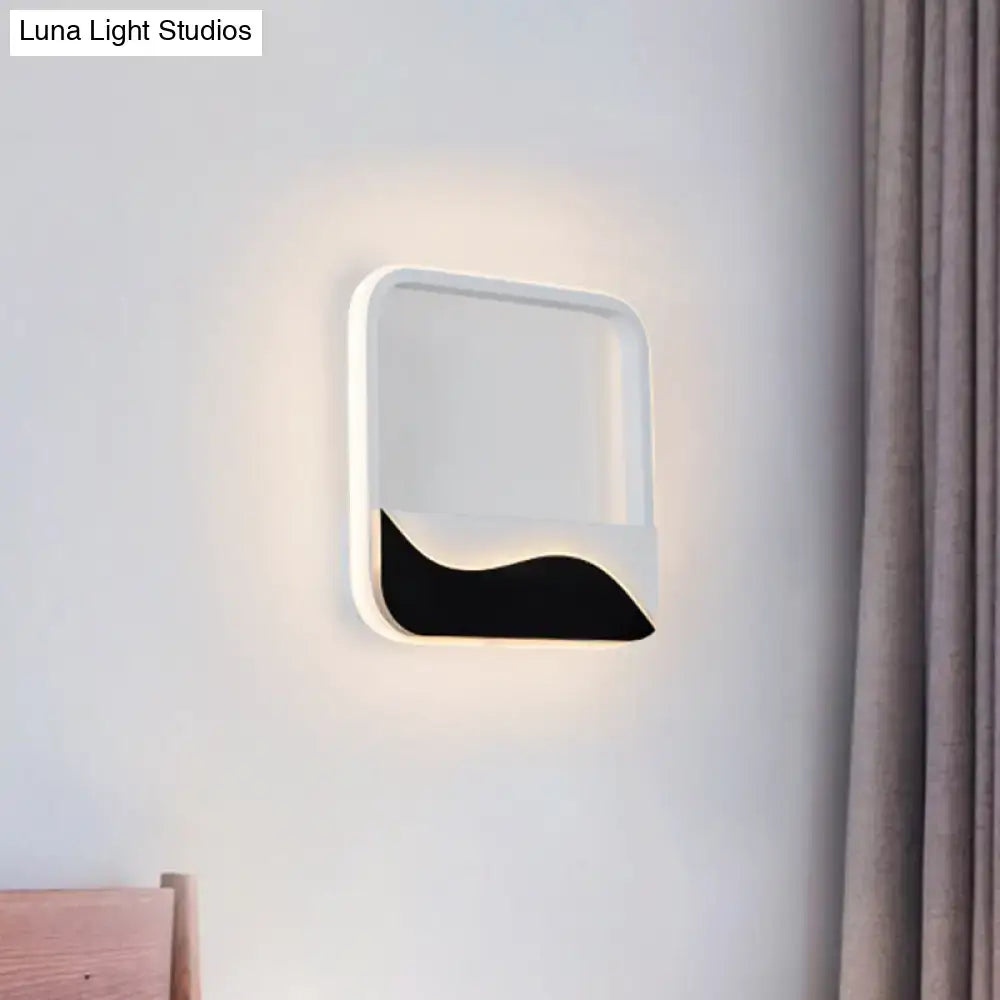 Modern black and white wave led wall light with sleek frame and bold accent emitting soft ambient light for bedroom wall lamp