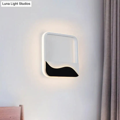 Modern black and white wave led wall light with sleek frame and bold accent emitting soft ambient light for bedroom wall lamp