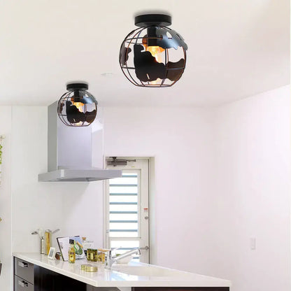 Modern black metal globe ceiling light shade with wireframe design and cutout continents for living room ceiling light