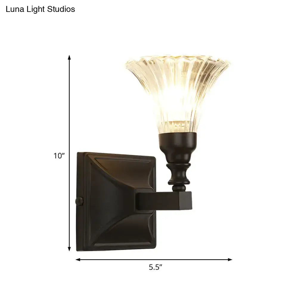 Modern black wide flare flush mount wall sconce with dark bronze finish and fluted translucent glass shade for bedroom use