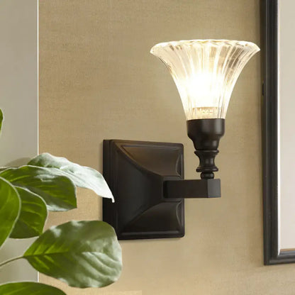 Modern black wide flare flush mount wall sconce with warm-toned fluted glass shade and dark bronze finish for bedroom lighting