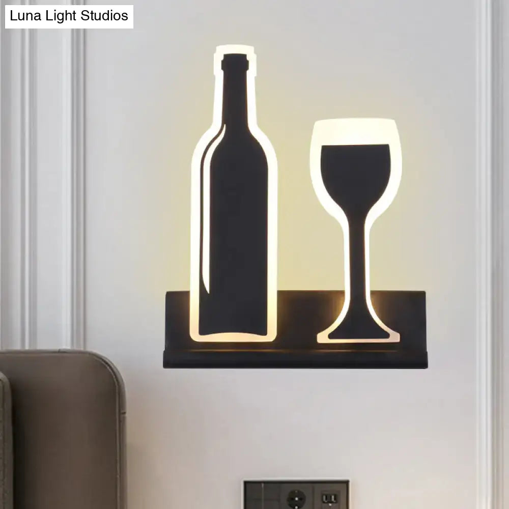 Modern black sconce light shaped like a wine bottle and glass with warm led illumination for dining room decor fixture height