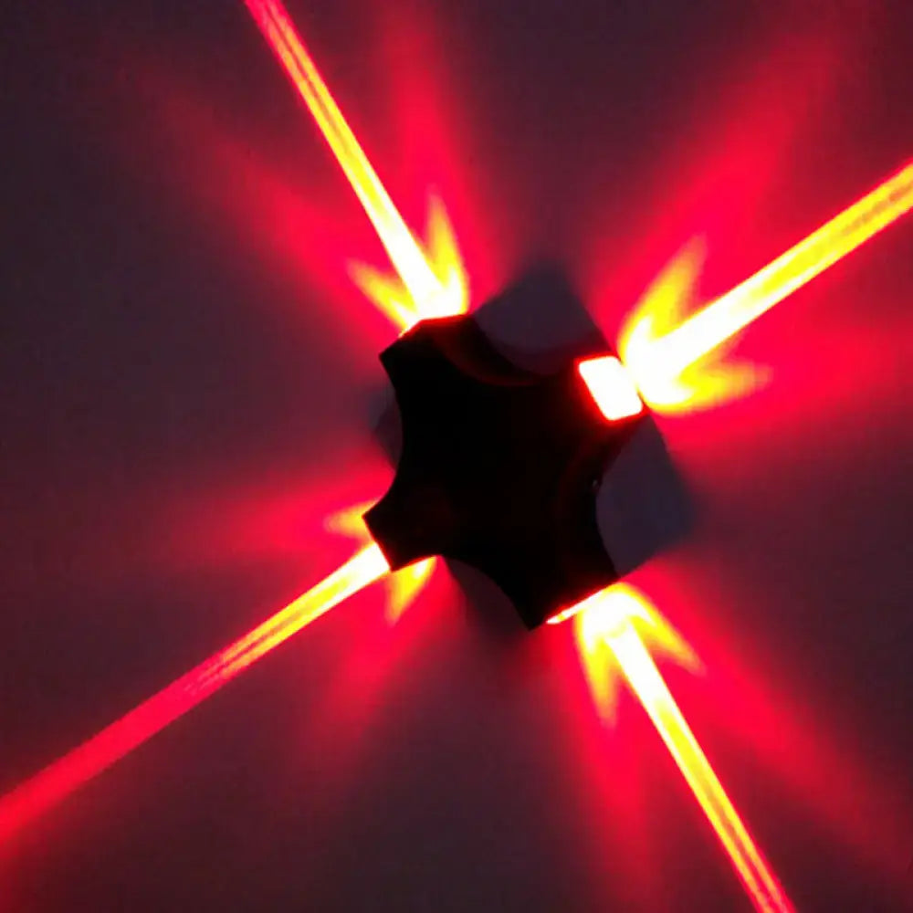 Black x shaped wall mount lamp with rgb color led emitting vibrant red and yellow beams for modern bedroom use