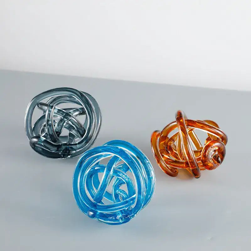 Modern blue amber and gray glass coil ball decorative figurine with three translucent glass spheres woven with interlocking rings