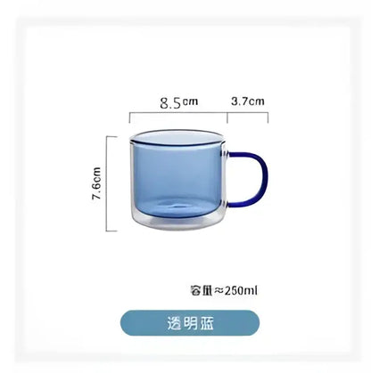 A transparent blue double-walled glass mug with a dark blue handle in a modern glass mugs set for dining