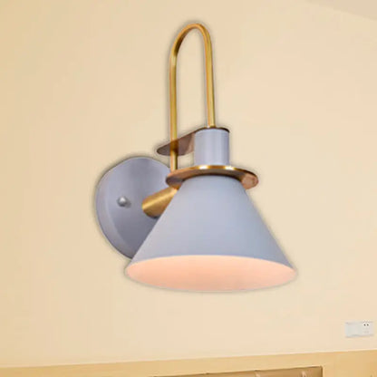 Modern blue and brass pyramid wall sconce with e26 e27 light socket featuring a sleek curved brass arm and light blue shade