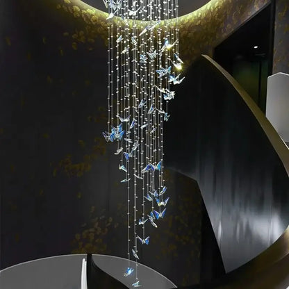 Elegant decorbites butterfly crystal chandelier with cascading clear and blue butterfly ornaments on golden fixture