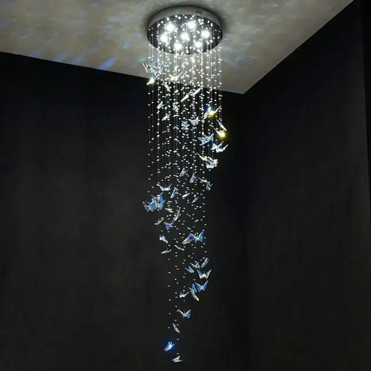 Modern blue and clear butterfly crystal chandelier by decorbites with cascading crystals and bright white lights for staircase decor