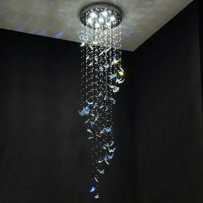 Modern blue and clear crystal butterfly rotating chandelier with cascading strings and glowing decorbites crystal butterfly ornaments