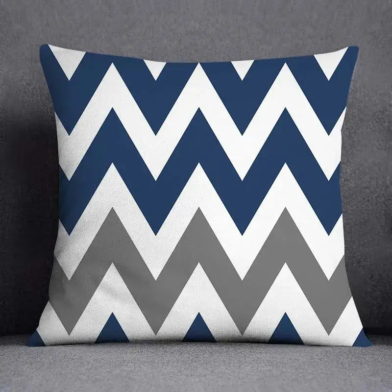 Square throw pillow with bold navy blue white and gray chevron pattern featuring modern geometric floral design