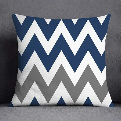 Square throw pillow with bold navy blue white and gray chevron pattern featuring geometric floral design for living room