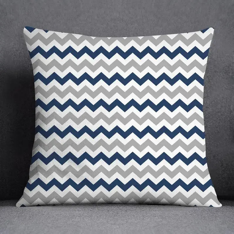 Square throw pillow with bold navy blue light gray and white chevron pattern featuring a modern geometric floral design