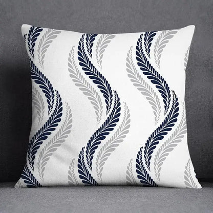 A square throw pillow with a white base and geometric floral design in navy blue and gray for living room use